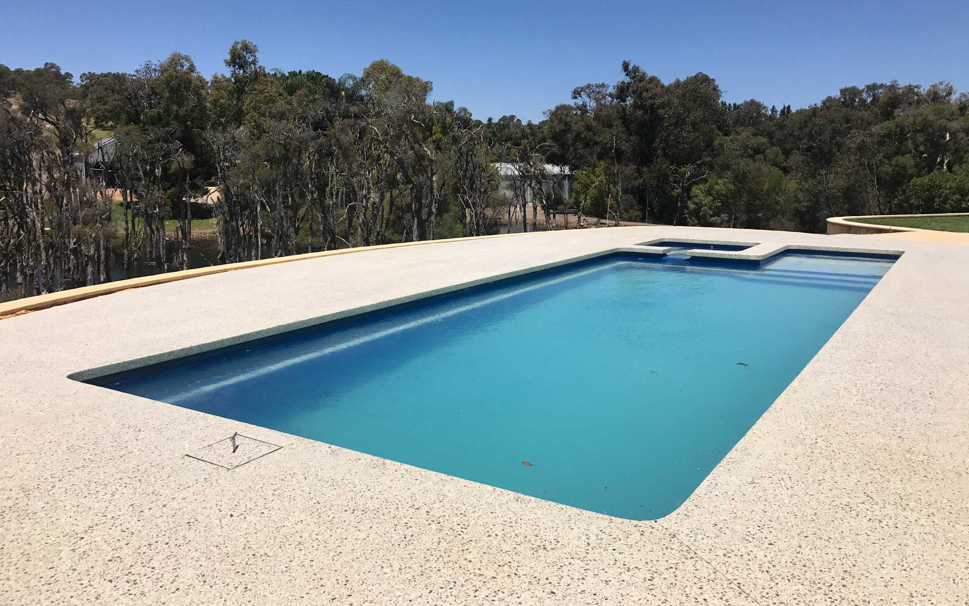 inground pool with concrete surround